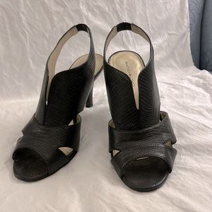 Black high heeled sling back shoes